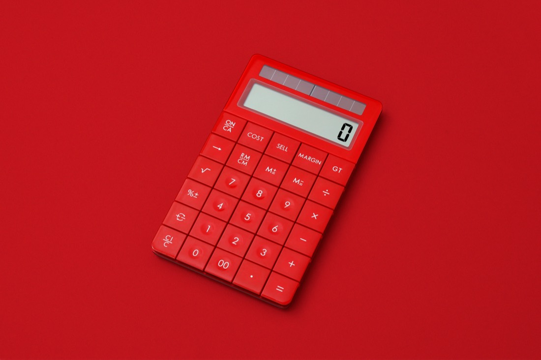 A red calculator on a red surface, representing disciplined financial stewardship